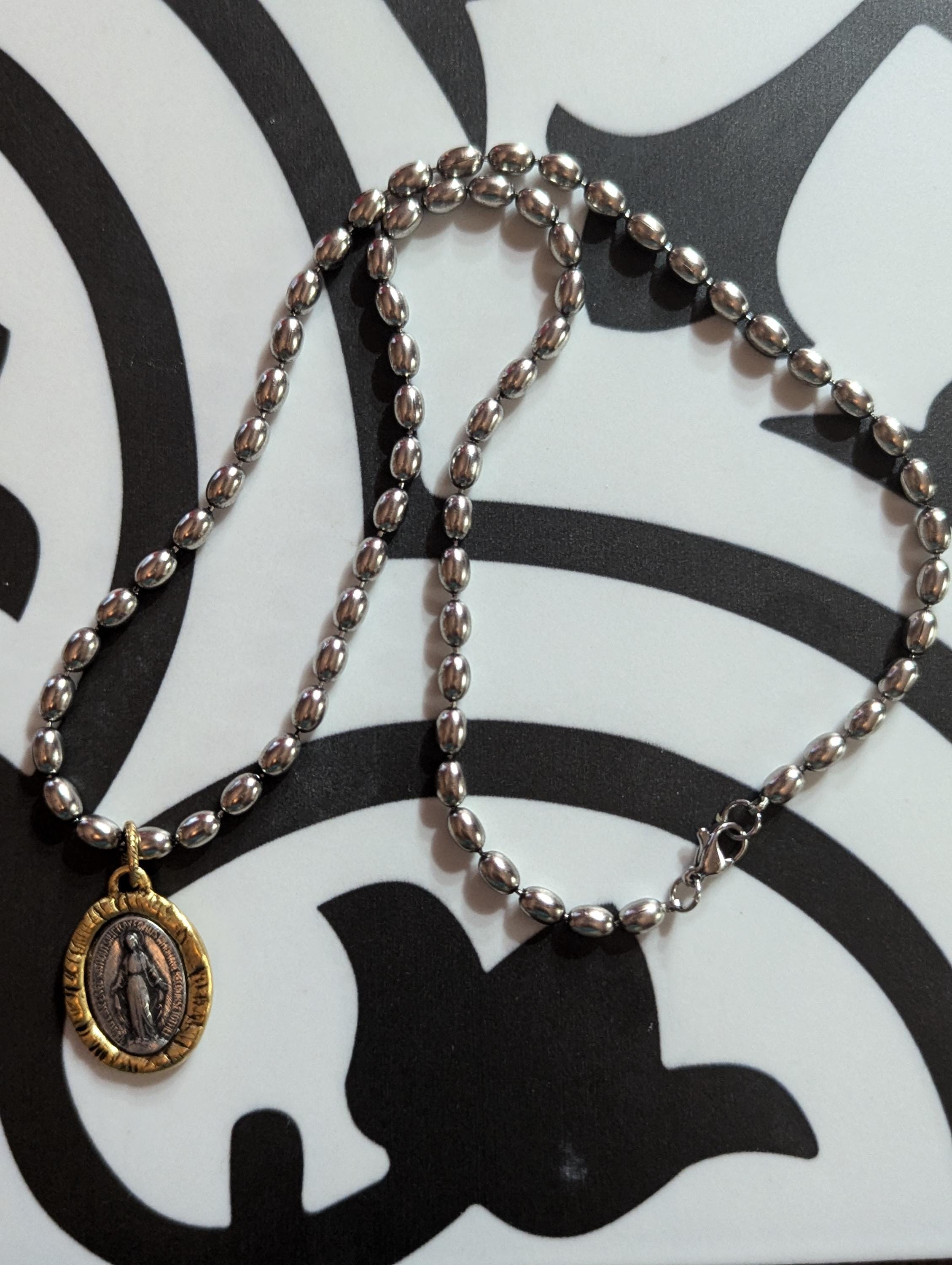 Silver chain with two tone Mary Medal with prayer.